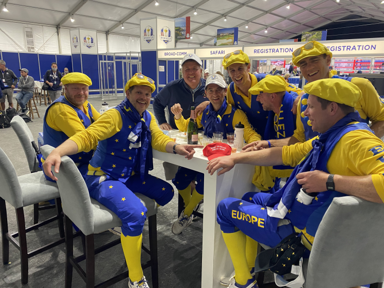 Members of the "Guardians of the Cup" toast their trip from the media center at Whistling Straits.