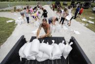 <p>Ryan Kaye loads sandbags into his truck at a makeshift filling station provided by the county as protection ahead of Hurricane Irma, Friday, Sept. 8, 2017, in Palm Coast, Fla. (Photo: David Goldman/AP) </p>