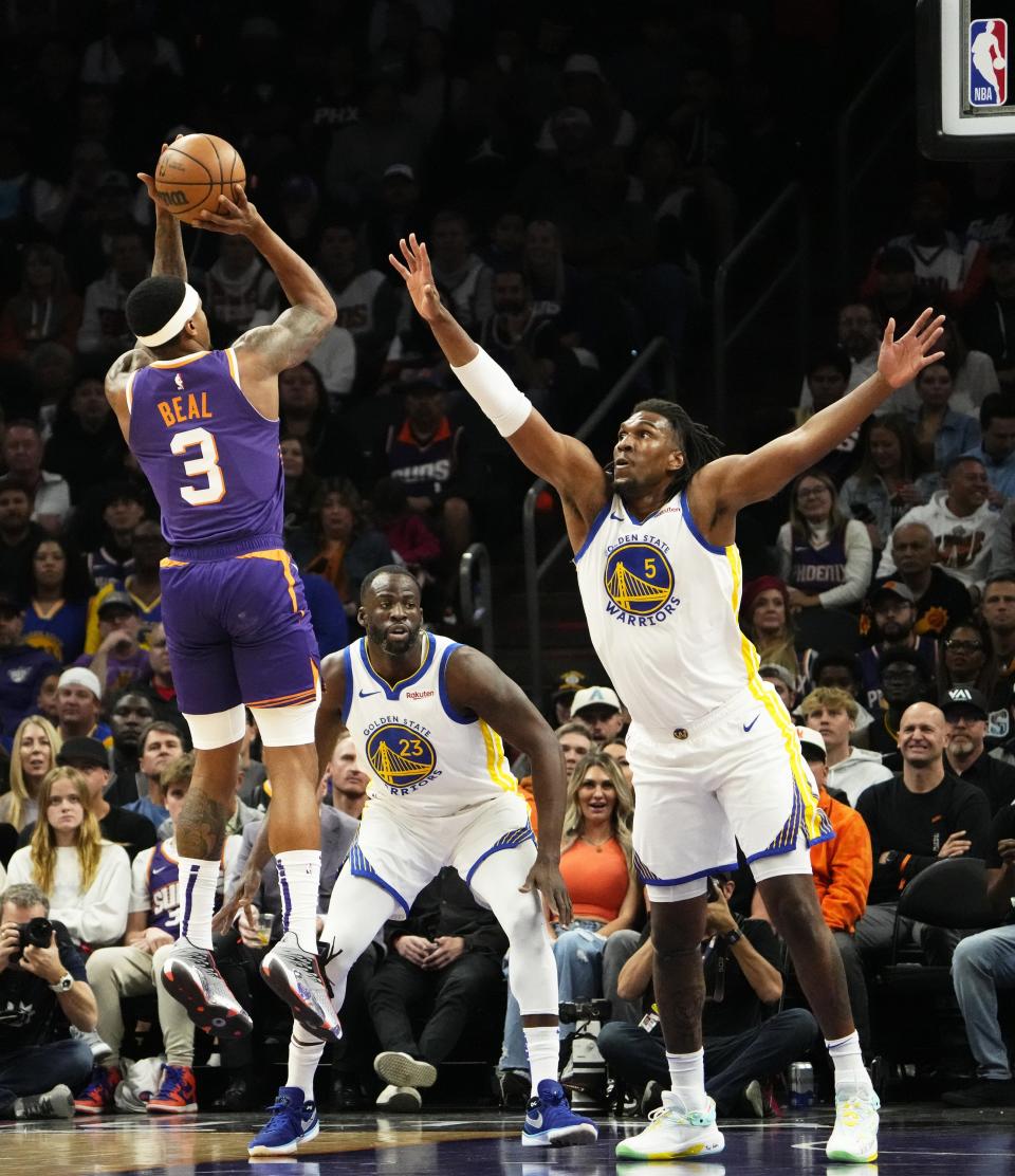 Phoenix Suns guard Bradley Beal (3) shoots a jumper over Golden State Warriors forward Kevon Looney (5) in the first half at Footprint Center in Phoenix on Dec. 12, 2023.