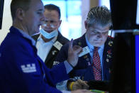 Trader John Panin, right, works on the floor of the New York Stock Exchange, Wednesday, Dec. 1, 2021. The latest move in Wall Street's jolting roller-coaster ride is back up, as stocks, oil and bond yields climb in early Wednesday trading to recover some of their sharp losses from the day before. (AP Photo/Richard Drew)