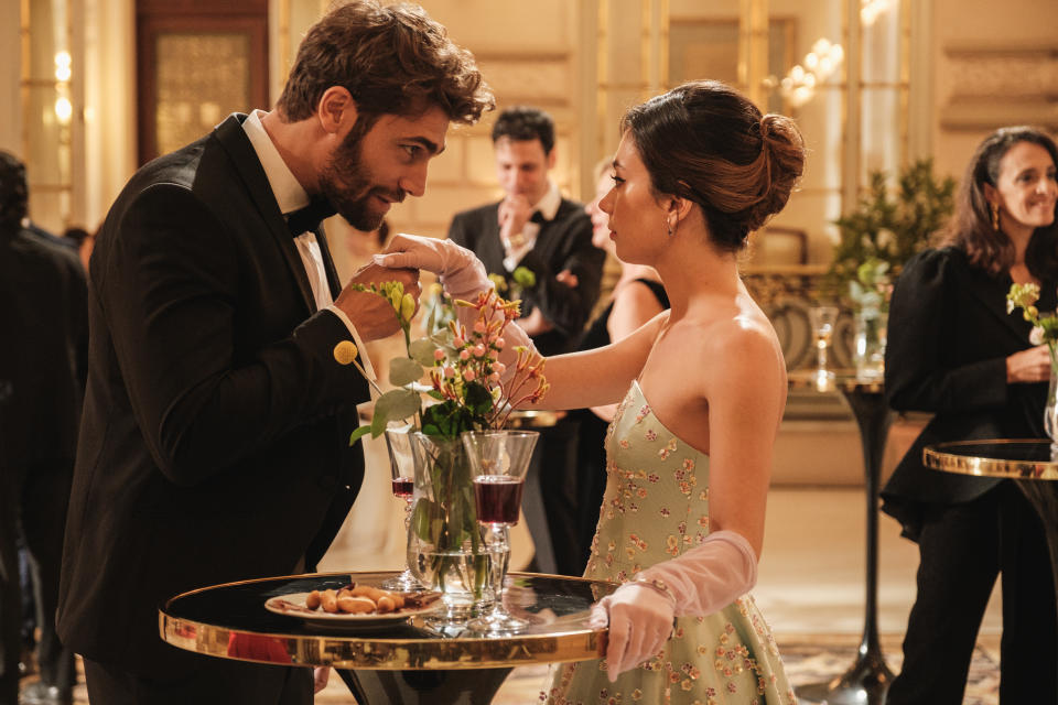 Filippo kissing Margot's hand.