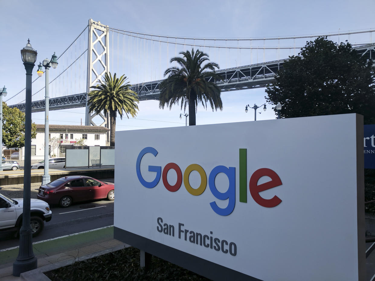 This photo shows signage outside the offices of Google in San Francisco with the San Francisco-Oakland Bay Bridge in the background, Wednesday, Oct. 31, 2018. Hundreds of Google employees are expected to temporality leave their jobs Thursday morning in a mass walkout protesting the internet company's lenient treatment of executives accused of sexual misconduct. The San Francisco office is one of the offices that the walkout will take place. (AP Photo/Michael Liedtke)