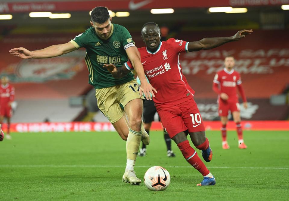 Sheffield United's John Egan (left) in action with Liverpool's Sadio Mane.