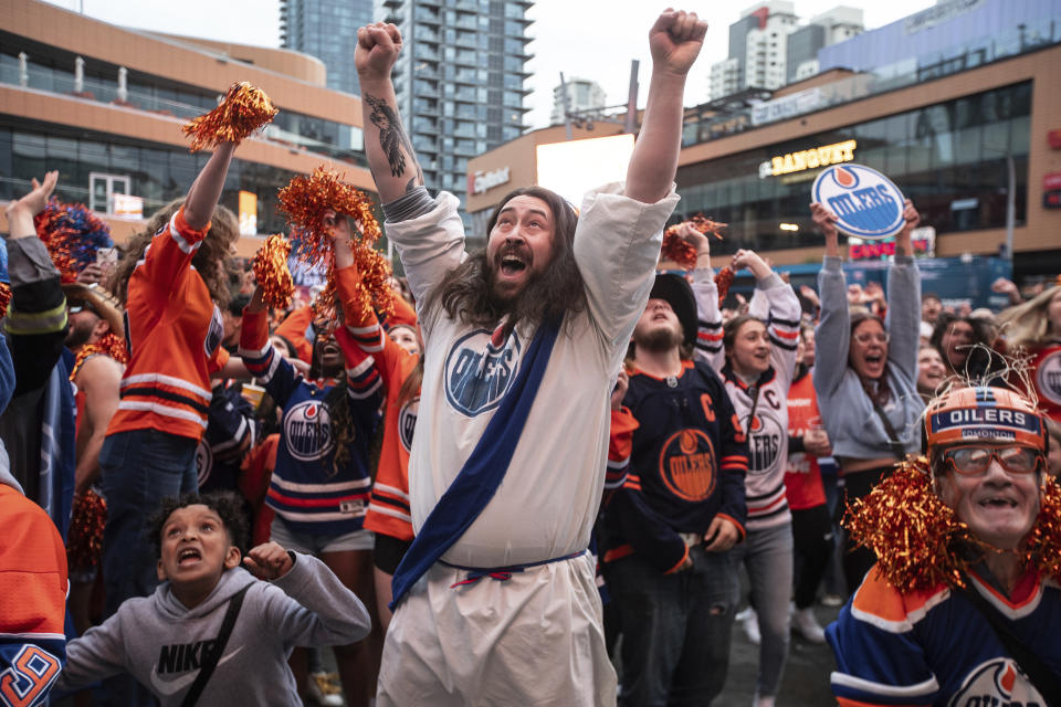 Edmonton Oilers fans celebrate as the Oilers defeated the Florida Panthers, as fans watched coverage of Game 5 of the NHL hockey Stanley Cup Final, Tuesday, June 18, 2024, in Edmonton, Alberta. (Jason Franson/The Canadian Press via AP)