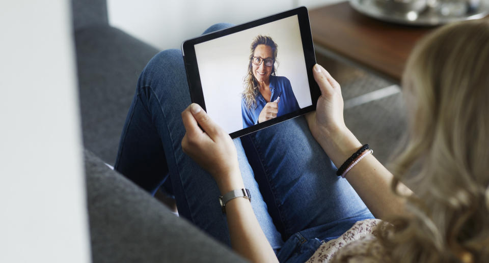We asked mental health professionals about how to make the most of online therapy. (Image via Getty Images). 