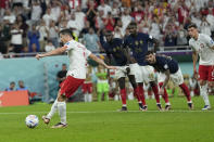 Poland's Robert Lewandowski scores on a penalty kick during the World Cup round of 16 soccer match between France and Poland, at the Al Thumama Stadium in Doha, Qatar, Sunday, Dec. 4, 2022. (AP Photo/Ebrahim Noroozi)