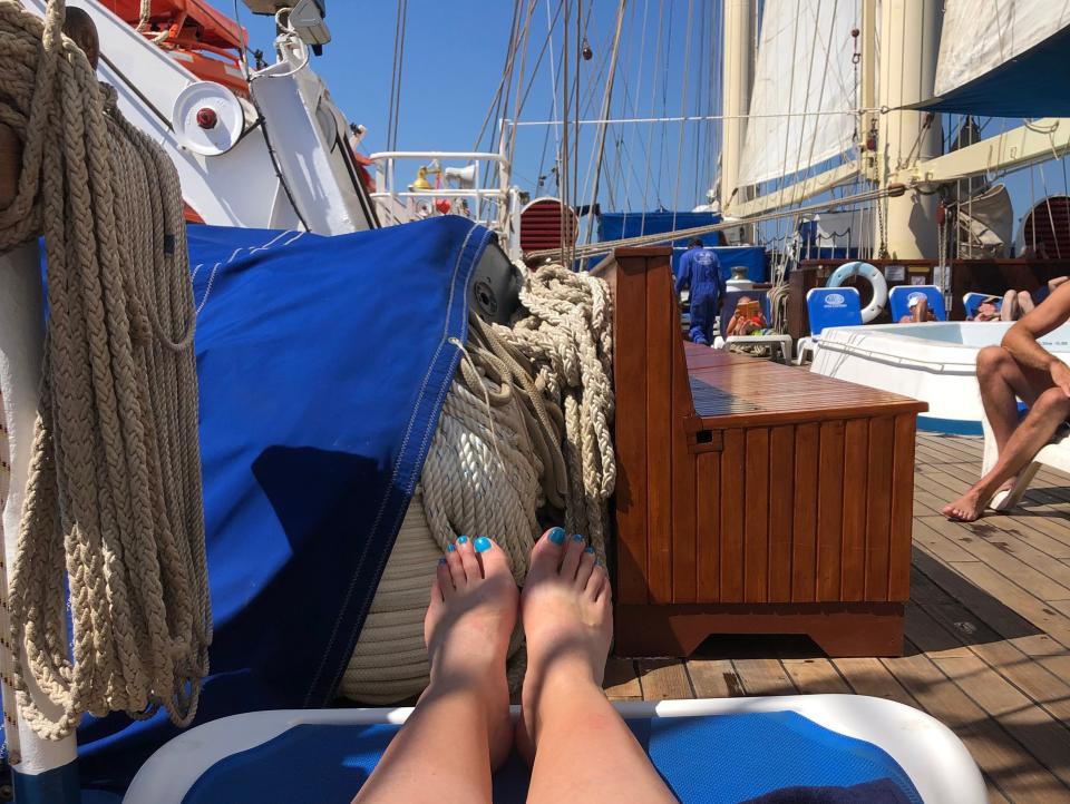 Legs sunbathing on Star Clippers sundeck, Laura Kiniry, "I went on a tall sailing ship in the French Riviera for a week and felt transported to a bygone era."