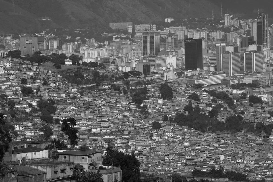 HOLD FOR DARIO LOPEZ - Cinderblock homes cover a poor neighborhood, known as a "barrio," in Caracas, Venezuela, Wednesday, March 1, 2023. (AP Photo/Ariana Cubillos)