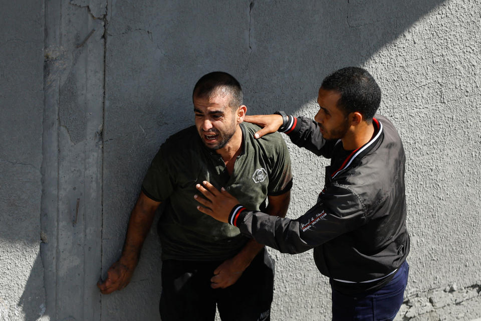 Men at the site of Israeli strikes on Rafah.