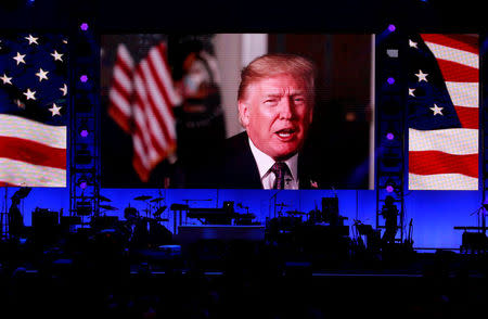 President Donald Trump in a video message as five former U.S. presidents, Jimmy Carter, George H.W. Bush, Bill Clinton, George W. Bush, and Barack Obama attended a concert at Texas A&M University benefiting hurricane relief efforts in College Station, Texas, U.S., October 21, 2017. REUTERS/Richard Carson/Files