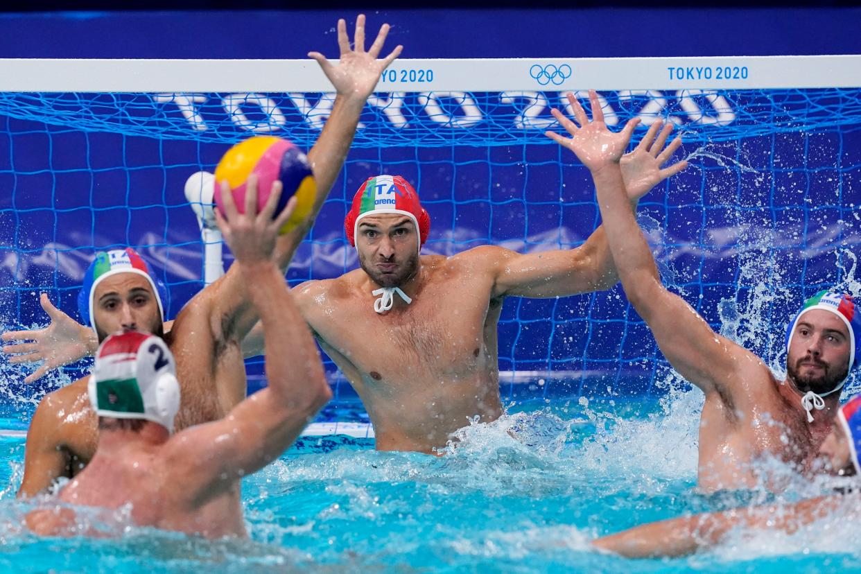 Italy's goalkeeper Marco del Lungo, center, watches as Hungary's Daniel Angyal (2) prepares to shoot during a preliminary round men's water polo match at the 2020 Summer Olympics, Monday, Aug. 2, 2021, in Tokyo, Japan.