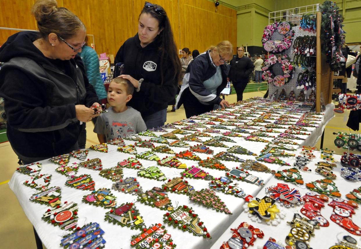 Shoppers look over the hand made ornaments for sale during the 31st Annual Holiday Scholarship Craft Fair held at GNB Voc-Tech High School in New Bedford.

[DAVID W. OLIVEIRA/STANDARD-TIMES SPECIAL/SCMG]