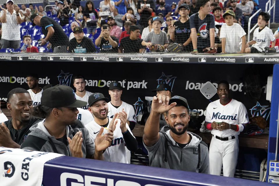 Miami Marlins pitcher Sandy Alcantara waves to the crowd as he is acknowledged during the fourth inning of a baseball game against the Atlanta Braves, Wednesday, Oct. 5, 2022, in Miami. (AP Photo/Wilfredo Lee)