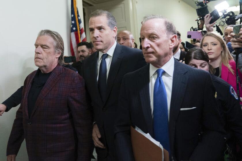 Hunter Biden, center, President Joe Biden's son, accompanied by his attorney Abbe Lowell, right, leave a House Oversight Committee hearing as Republicans are taking the first step toward holding him in contempt of Congress, Wednesday, Jan. 10, 2024, on Capitol Hill in Washington. (AP Photo/Jose Luis Magana)