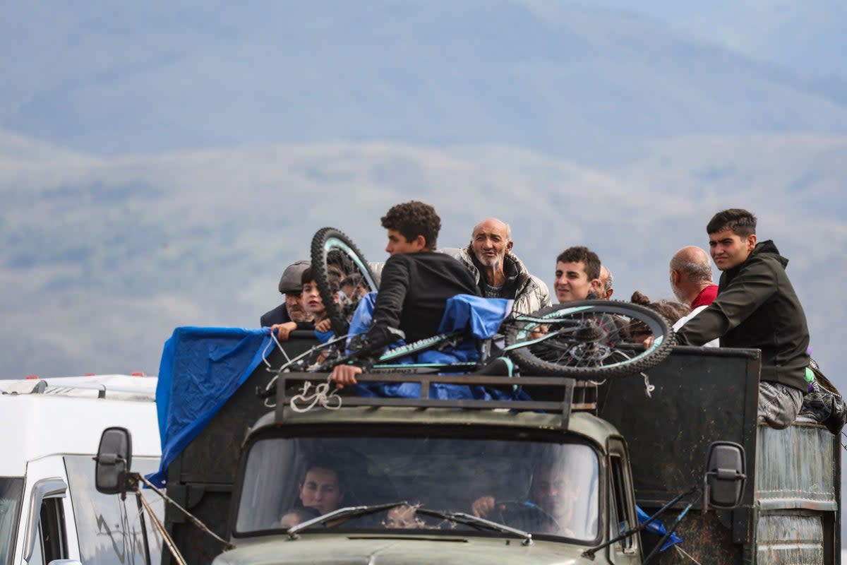 Refugees sit in a truck near the town of Kornidzor, Armenia on Tuesday (AFP/Getty)