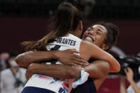 United States' Jordan Thompson, rear, and United States' Justine Wong-Orantes celebrate winning the women's volleyball quarterfinal match between Dominican Republic and United States at the 2020 Summer Olympics, Wednesday, Aug. 4, 2021, in Tokyo, Japan. (AP Photo/Frank Augstein)