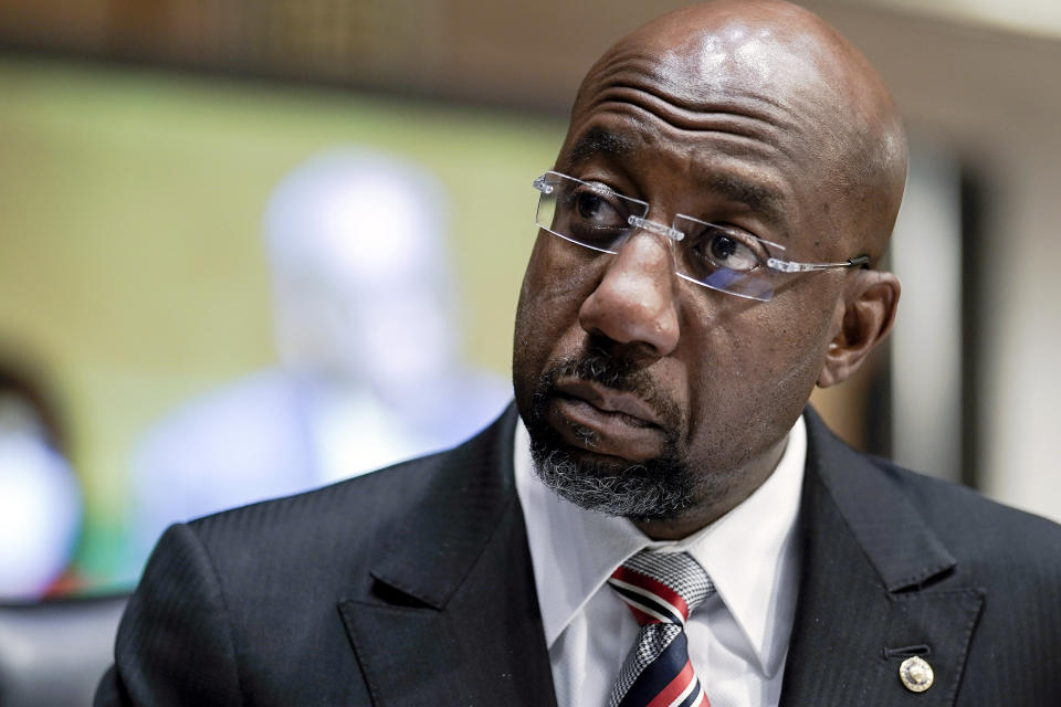 FILE- Sen. Raphael Warnock, D-Ga., listens during a Senate Banking, Housing and Urban Affairs Committee confirmation hearing on Feb. 3, 2022, in Washington. Herschel Walker's Republican rivals for U.S. Senate in Georgia are attacking him over reports by The Associated Press detailing police in Texas once confiscated a gun from Walker after a 2001 domestic disturbance, saying it adds to proof that Republicans risk losing the Senate race against Warnock if they nominate Walker and leave him vulnerable to attacks.(Ken Cedeno/Pool via AP, File)