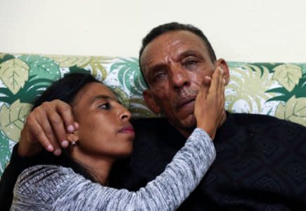 Addisalem Hadgu, 58, an Ethiopian state TV journalist, embraces his daughter Danayt Addisalem, after meeting for the first time in eighteen years, in Asmara, Eritrea July 19, 2018. REUTERS/Tiksa Negeri