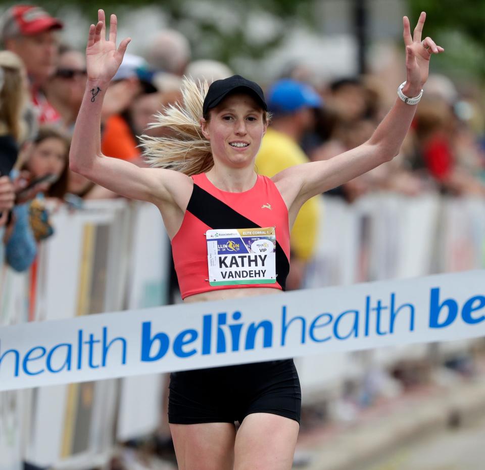 Kathy VanDehy of Menasha is the first female to cross the finish line of the Bellin Run 10k on June 10, 2023, in Green Bay, Wis.