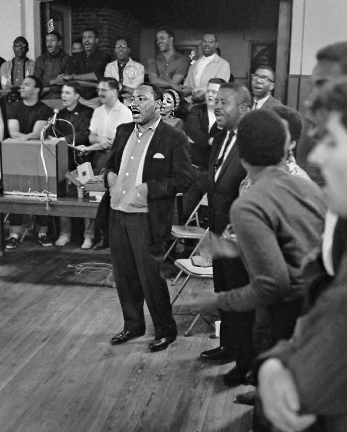 Martin Luther King Jr., center, sings at a Southern Christian Leadership Conference staff workshop held at the Penn Center on St. Helena Island in 1966.