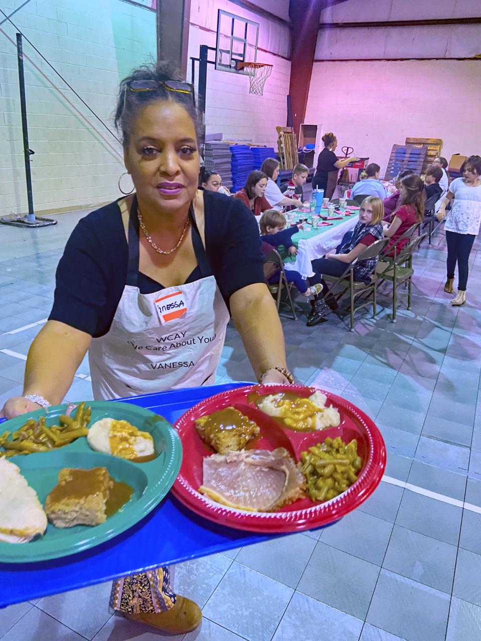 We Care About You (WCAY) founder Vanessa Lyons prepares to serve up huge plates filled with all the goodies at a Christmas dinner Dec. 1 at Friendship Baptist Church on Ball Camp Pike.