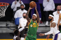 Utah Jazz guard Jordan Clarkson, center, shoots as Los Angeles Lakers guard Dennis Schroder, left, and forward Markieff Morris defend during the first half of an NBA basketball game Saturday, April 17, 2021, in Los Angeles. (AP Photo/Mark J. Terrill)