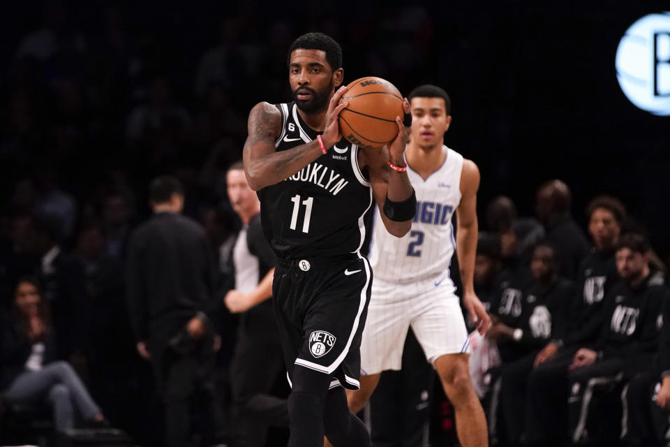 Brooklyn Nets guard Kyrie Irving (11) holds the ball during the first half of an NBA basketball game against the Orlando Magic, Monday, Nov. 28, 2022, in New York. (AP Photo/Julia Nikhinson)