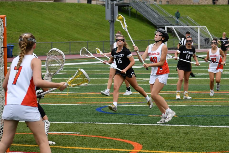 Cherokee junior Erin St. John shoots and scores before Southern senior Summer Davis can close in