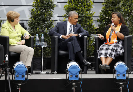 German Chancellor Angela Merkel, former U.S. President Barack Obama and Sierra Sims attend a discussion. REUTERS/Axel Schmidt