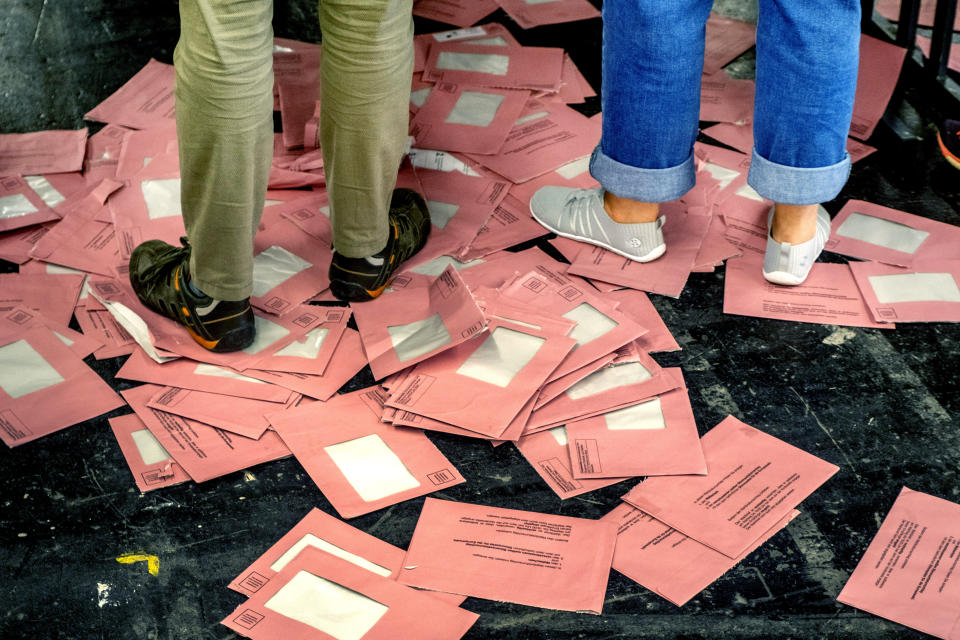 Empty envelopes of postal ballots for the European elections lie on the floor in a hall of the fair sound in Frankfurt, Germany, Sunday, June 9, 2024. (AP Photo/Michael Probst)