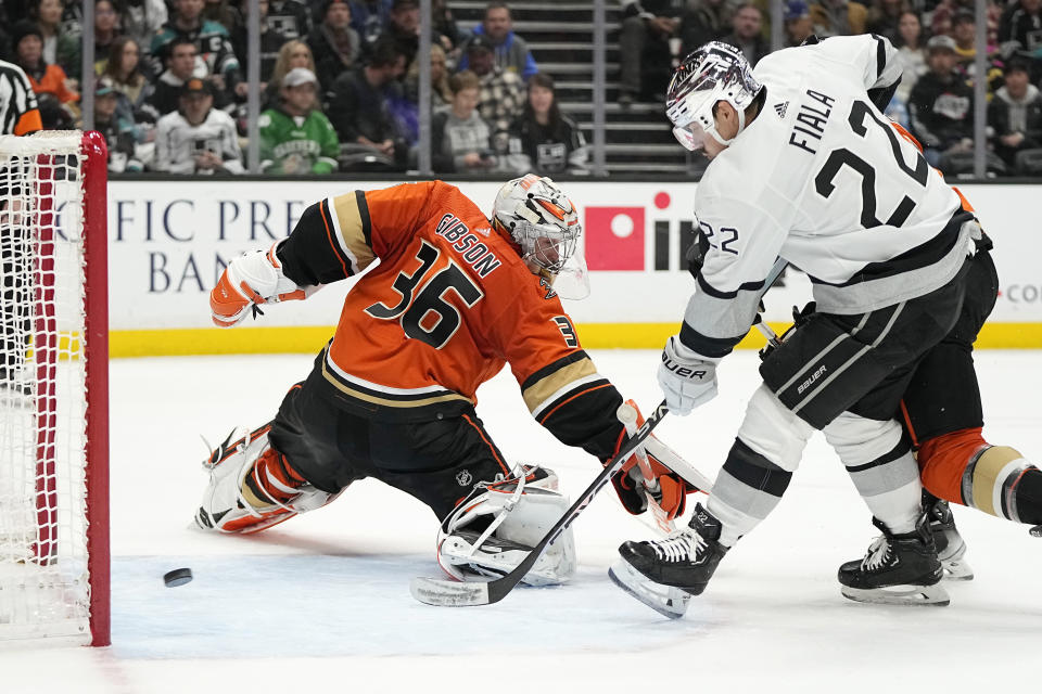 Anaheim Ducks goaltender John Gibson, left, is scored on by Los Angeles Kings right wing Adrian Kempe as left wing Kevin Fiala watches during the second period of an NHL hockey game Friday, Feb. 17, 2023, in Anaheim, Calif. (AP Photo/Mark J. Terrill)
