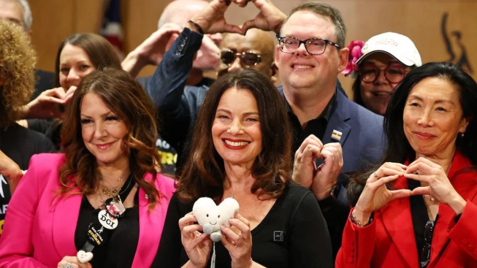 Fran Drescher (center) shows off her heart plushie at the SAG-AFTRA press conference on Nov. 10