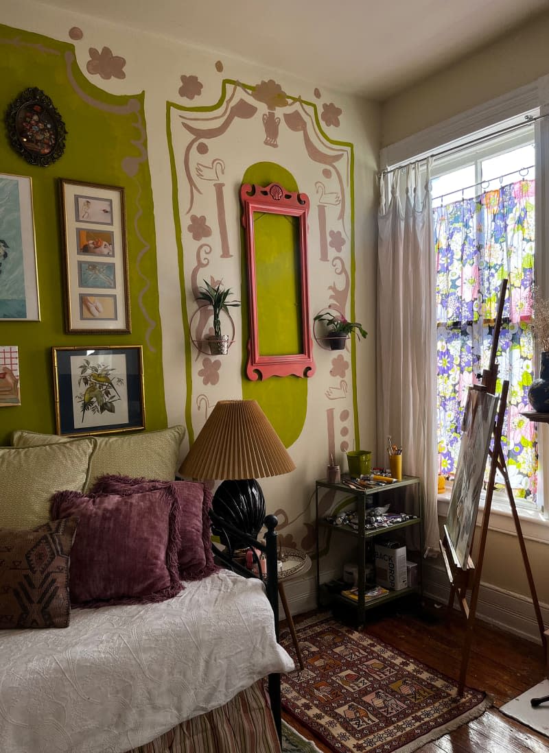 Office, guest room, studio with decoratively painted green, pink, and white walls.