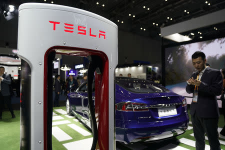 FILE PHOTO - A Tesla sign is seen during the China International Import Expo (CIIE), at the National Exhibition and Convention Center in Shanghai, China November 6, 2018. REUTERS/Aly Song