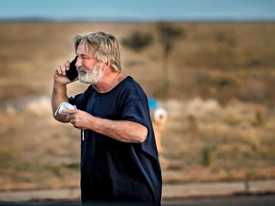 Alec Baldwin speaks on the phone in the parking lot outside the Santa Fe County Sheriff's Office in Santa Fe, N.M., after he was questioned about a shooting on the set of the film Rust on the outskirts of Santa Fe, Thursday, Oct. 21, 2021. Baldwin fired a prop gun on the set, killing cinematographer Halyna Hutchins and wounding director Joel Souza, officials said.  (Jim Weber/Santa Fe New Mexican/The Associated Press - image credit)