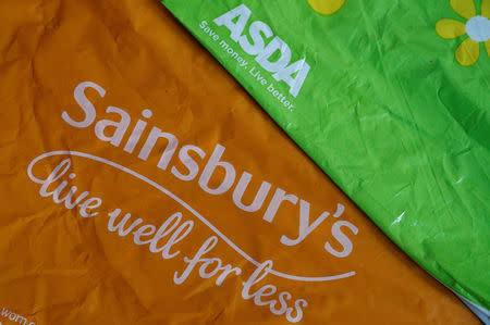 FILE PHOTO: Shopping bags from Asda and Sainsbury's are seen in Manchester, Britain April 30, 2018. REUTERS/Phil Noble/illustration