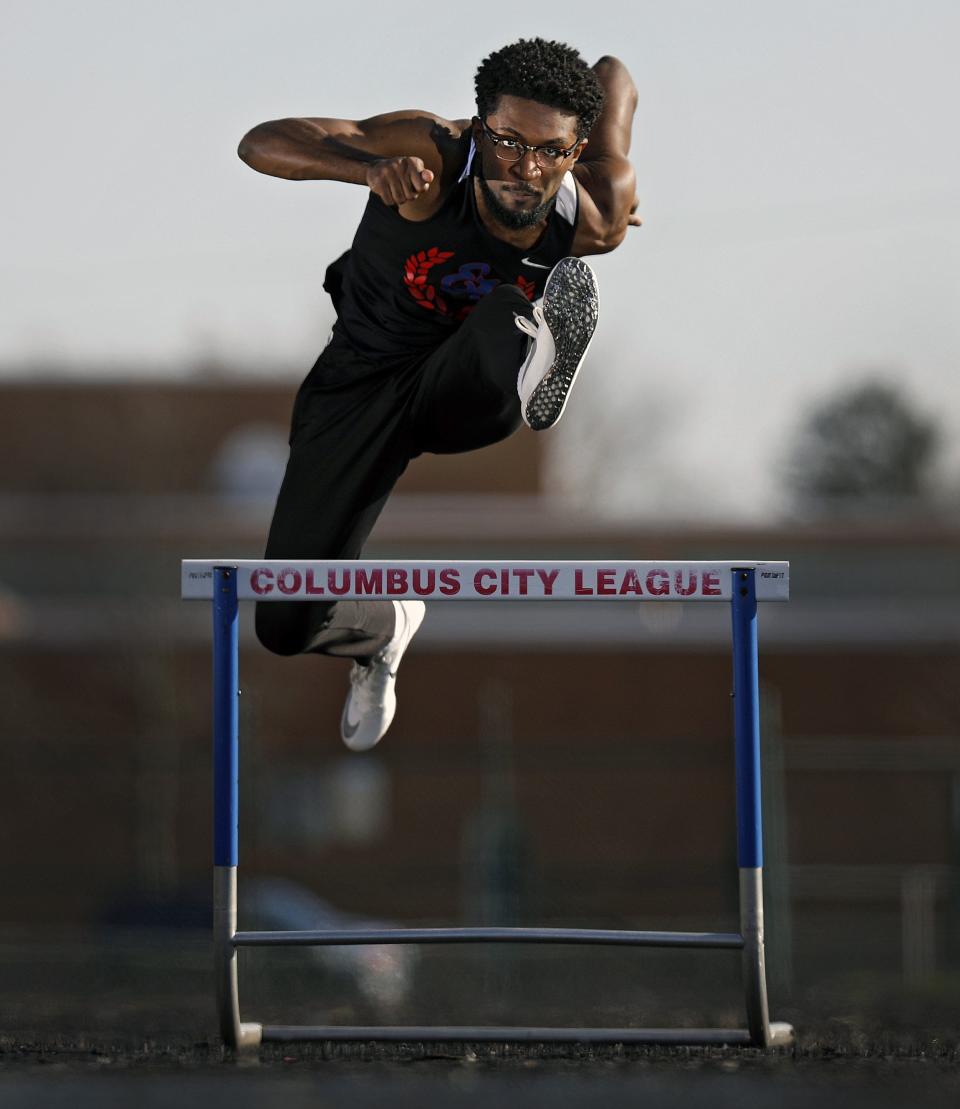 Eastmoor Academy track star Ira Graham IV jumps over a hurdle at Eastmoor Academy High School Stadium in Columbus, Ohio on April 8, 2020.  Graham lost his spring track season due to the coronavirus.