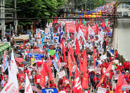 Thousands of Philippine workers carry placards while marching towards the Malacanang Presidential Palace during a May Day rally at Espana, metro Manila , Philippines May 1, 2018. REUTERS/Romeo Ranoco