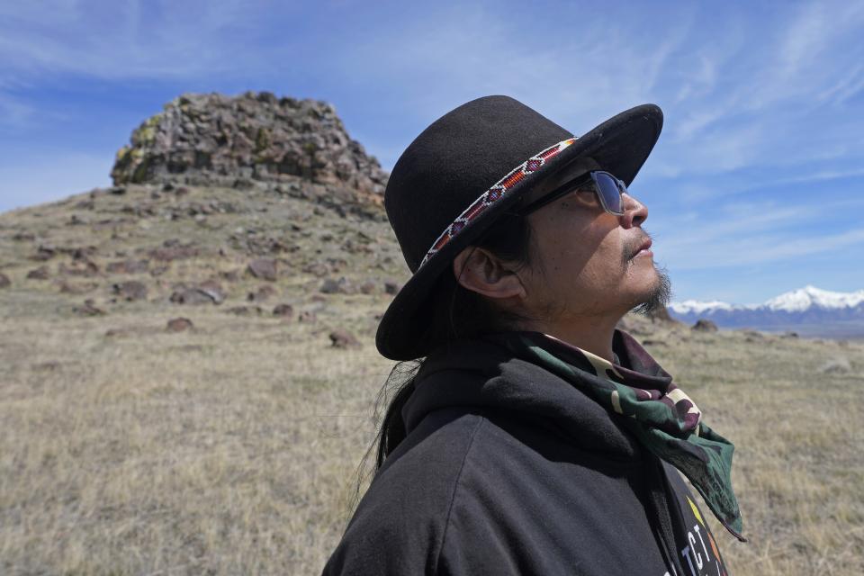 Gary McKinney, a spokesman for People of Red Mountain and a member of the nearby Duck Valley Shoshone-Paiute Tribe, walks near Sentinel Rock on April 25, 2023, outside of Orovada, Nev. A huge lithium mine under construction in northern Nevada is at the center of a dispute over President Joe Biden's clean energy agenda. McKinney said the project will cause irreparable damage. (AP Photo/Rick Bowmer)