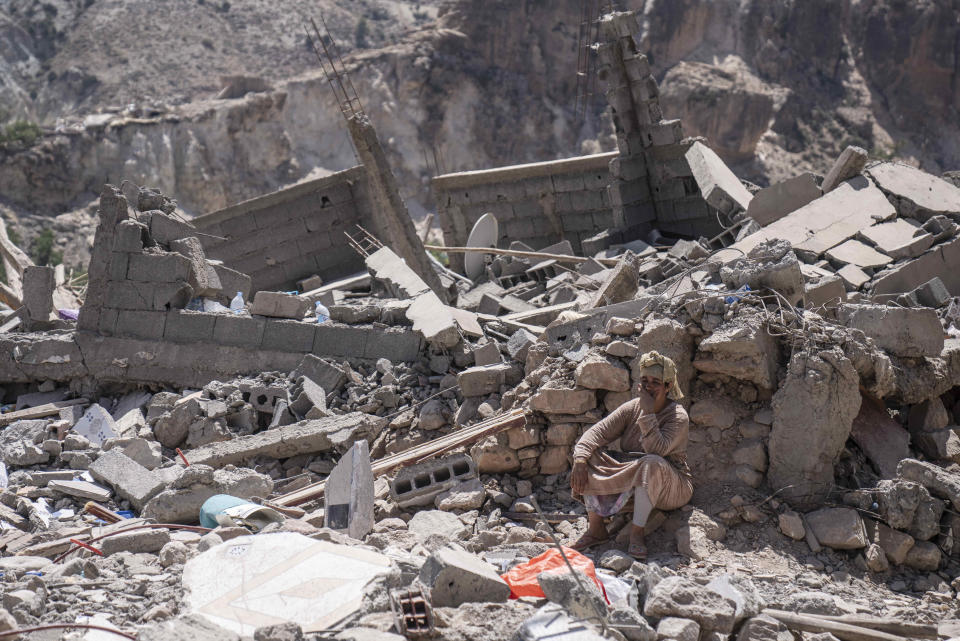 A person sits amongst the wreckage that was caused by earthquake, in the town of Imi N'tala, outside Marrakech, Morocco, Tuesday, Sept. 12, 2023. (AP Photo/Mosa'ab Elshamy)