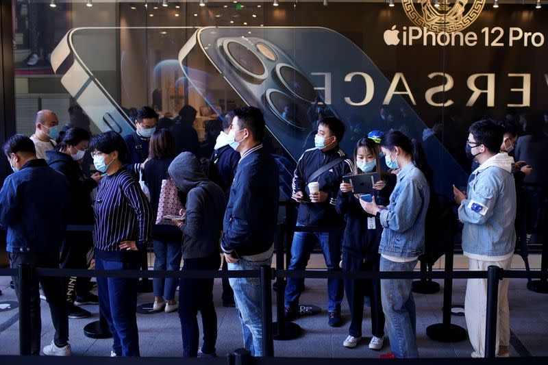 Gente hace fila esperando en una Apple Store antes de la salida a venta del nuevo iPhone 12, con capacidad 5G, en Shanghái