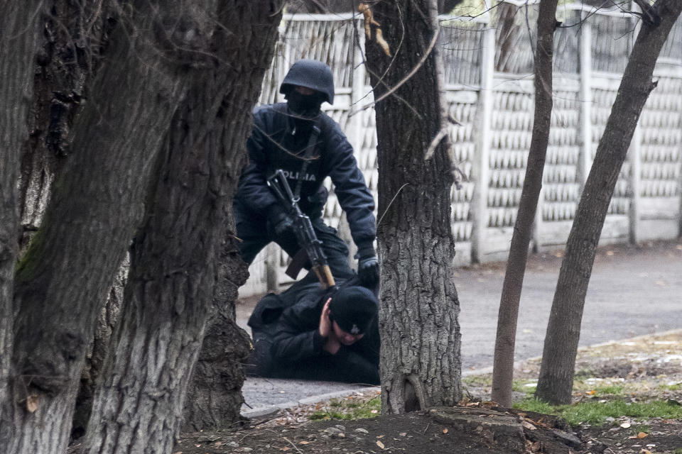 An armed riot police officer detains a protester during a security anti-terrorists operation in a street after clashes in Almaty, Kazakhstan, Saturday, Jan. 8, 2022. (AP Photo/Vasily Krestyaninov)