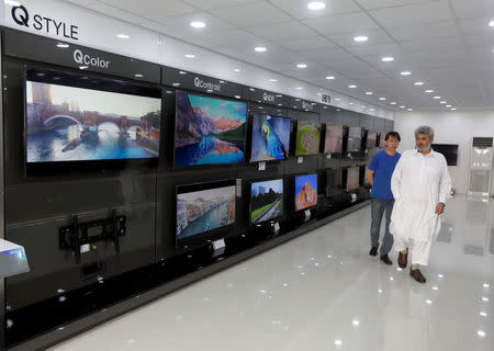 Afghan men arrive at a Samsung shop to buy a TV in Kabul, Afghanistan July 1, 2018. REUTERS/Omar Sobhani/Files