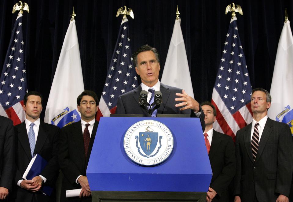 FILE - In this June 30, 2005 file photo, then-Massachusetts Gov. Mitt Romney speaks during a news conference announcing the new state budget as members of his staff look on at the Statehouse in Boston. What worked in the corporate boardroom for Mitt Romney didn't fly in the more raucous corridors of the Massachusetts Legislature. The Republican took over as governor in 2003 after a long, successful career as CEO at private equity firm Bain Capital, where it was pretty much Romney's way or the highway. (AP Photo/Michael Dwyer, File)