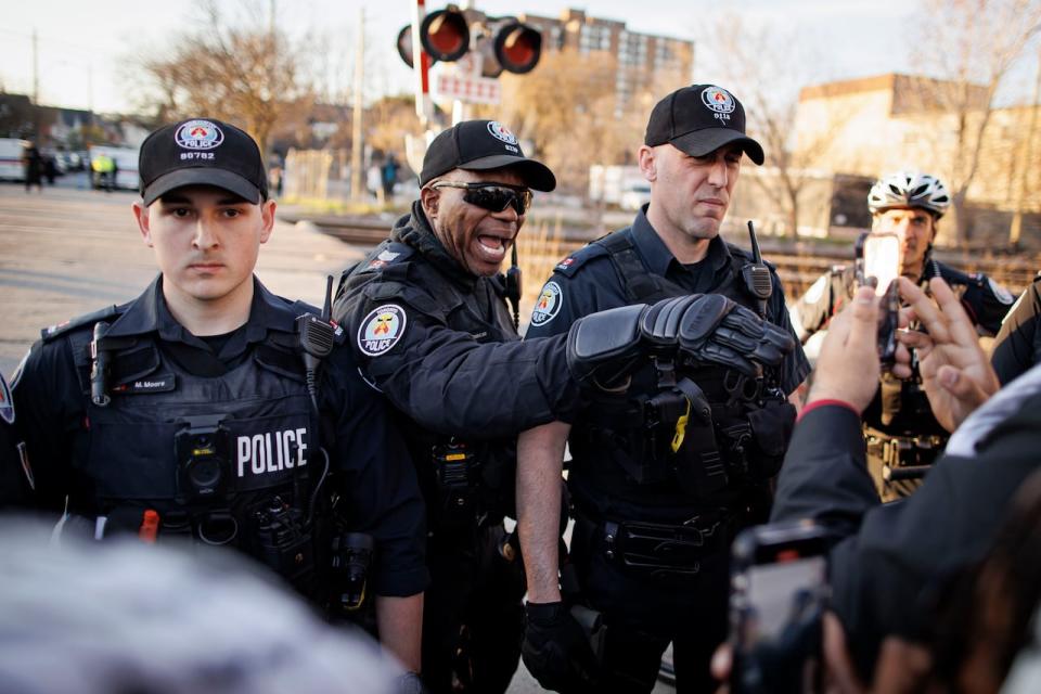 Toronto police confront protesters at a World War Out rally on April 16, 2024.