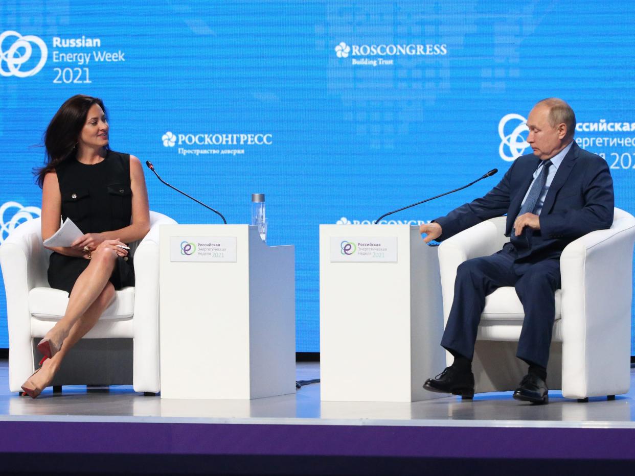 Russian President Vladimir Putin (R) and CNBC journalist Hadley Gamble (L) attend the Russian Energy Week 2001 plenary meeting on October 13, 2021 in Moscow, Russia.