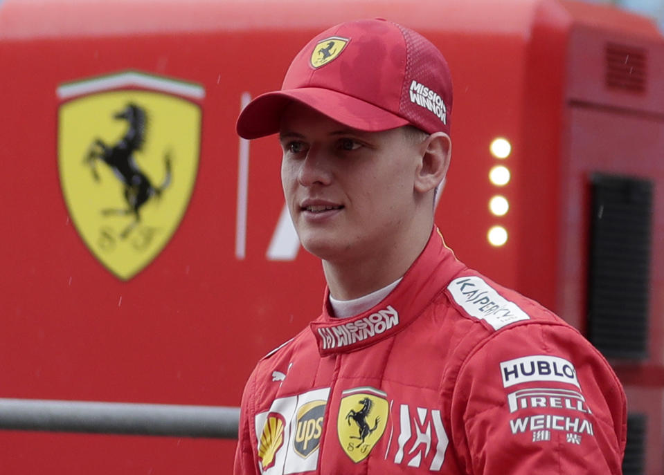 Mick Schumacher walks at the pit during his first F1 test for Ferrari at the Bahrain International Circuit in Sakhir, Bahrain, Tuesday, April 2, 2019. Mick Schumacher has moved closer to emulating his father Michael by driving a Ferrari Formula One car in an official test. Schumacher's father won seven F1 titles, five of those with Ferrari and holds the record for race wins with 91. (AP Photo/Hassan Ammar)
