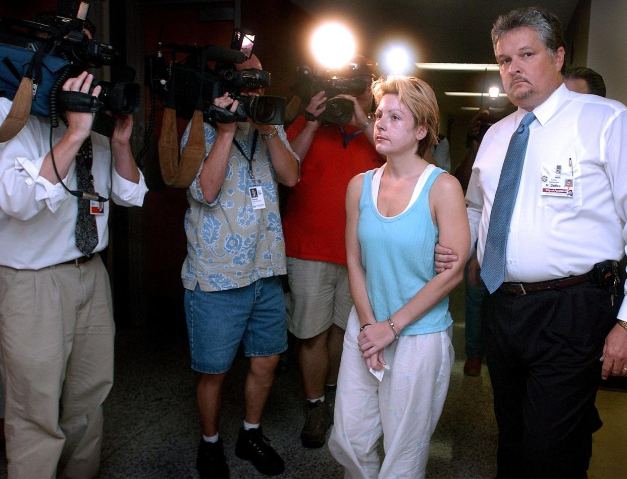 Michelle Theer was escorted to the magistrate's office Wednesday evening, Aug. 14, 2002, by Fayetteville Police Department's Lt. Mike Calfee. She was driven back to Fayetteville from Florida by sheriff's Deputy Dallas Tyree and Deputy Christy Booyer of the Fugitive Squad.