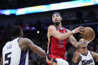 New Orleans Pelicans guard Jose Alvarado (15) looks to pass around Sacramento Kings guard De'Aaron Fox (5) in the second half of an NBA basketball play-in tournament game in New Orleans, Friday, April 19, 2024. The Pelicans won 105-98. (AP Photo/Gerald Herbert)