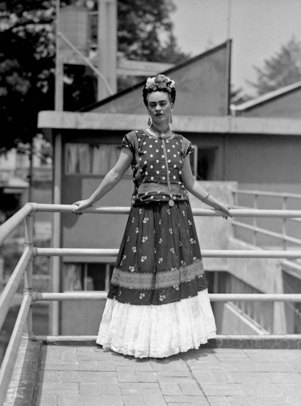 FILE - In this April 14, 1939 file photo, painter and surrealist Frida Kahlo, who was the wife of noted Mexican muralist Diego Rivera, poses at her home in Mexico City. A full collection from Kahlo's wardrobe will go on public display Nov. 22 in Mexico City after being locked for nearly 50 years in her armoires and dressers: jewelry, shoes and clothes that still carry the scent of the late artist's perfume and cigarette smoke or stains from painting. (AP Photo/File)